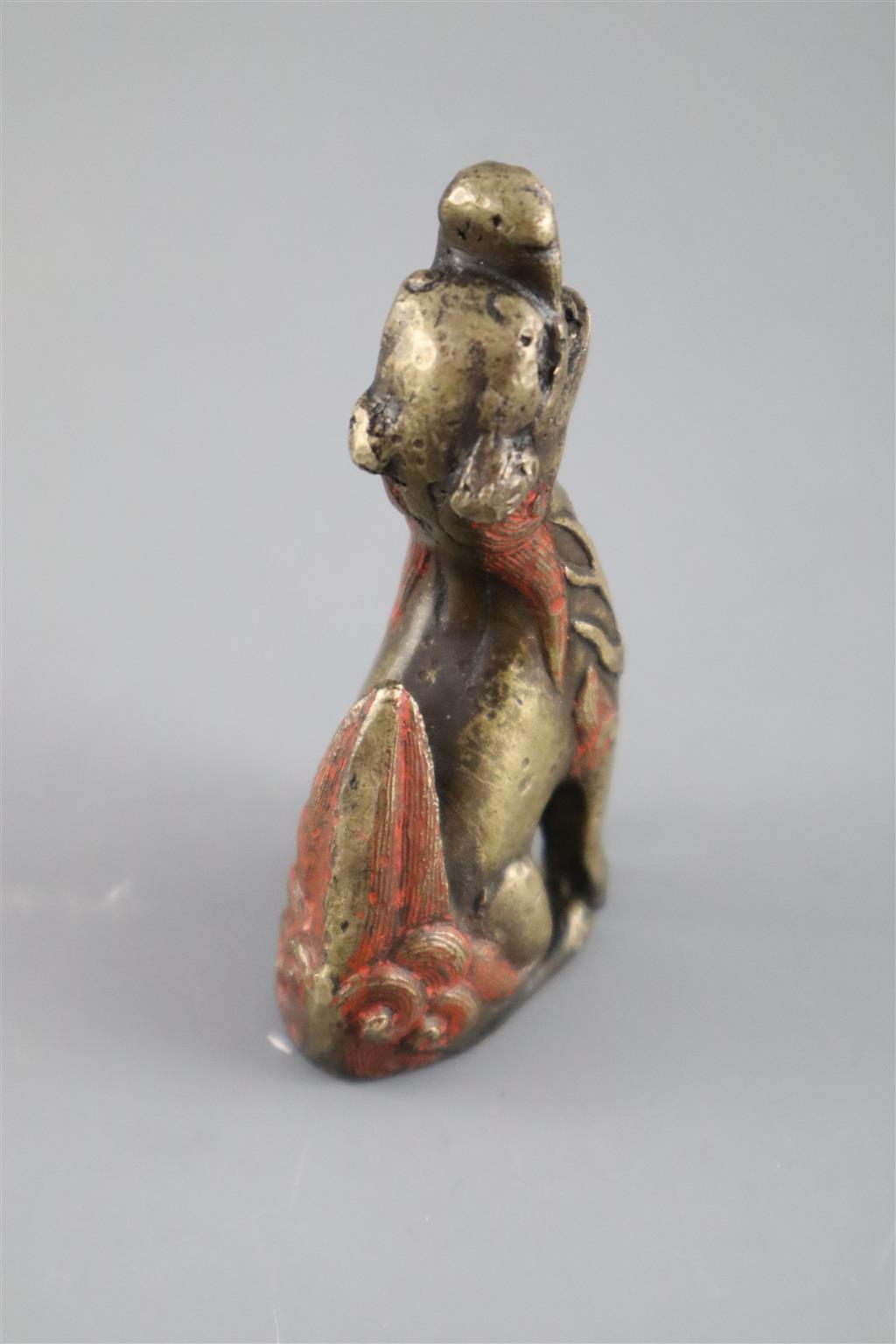 A Chinese bronze qilin scroll weight, 17th century, 8cm high